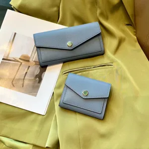 Blue leather women wallet long clutch and short bifold purse set with snap button closure.