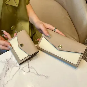 Detail view of stylish contrast color women wallet set, khaki and white leather design.