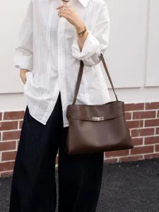 Retro brown leather Kelly underarm bag for women, chic vintage crossbody tote handbag.