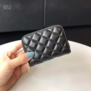 Black quilted leather card holder wallet with zip closure, classic pattern detail for women.