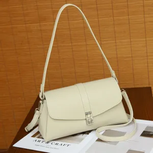 Chic off-white leather shoulder bag with metal clasp, elegant retro design for daily commute.