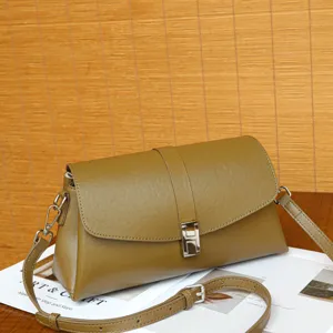 Stylish olive green leather crossbody bag featuring an elegant H-shaped metal clasp and strap.