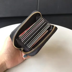 Black quilted leather accordion card holder with secure zip closure and multiple slots.