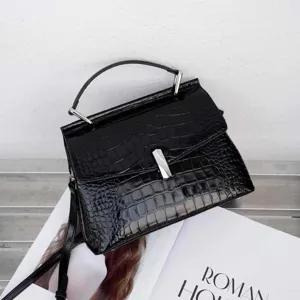Black crocodile pattern handbag detail, stylish top handle design for women fashion.