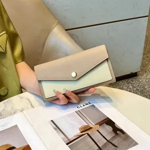 Two-tone long leather wallet for women, elegant envelope clutch with snap closure and large capacity.
