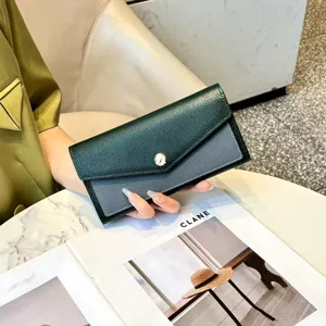Detailed close-up of a stylish two-tone long wallet with elegant clasp and textured leather.