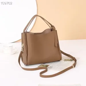 Genuine leather bucket shoulder bag for women, stylish crossbody tote with elegant knot design.