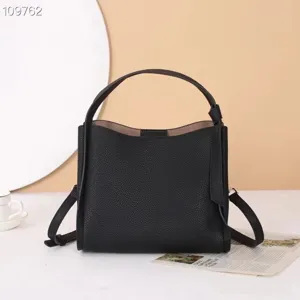Classic black leather shoulder bag with top handle and pebbled texture for women daily use.