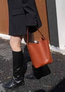 Brown minimalist bucket bag for women, stylish leather shoulder bag for daily commute and autumn.