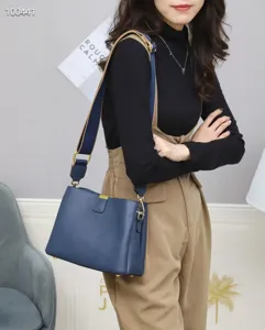 Stylish blue leather shoulder bag for women with wide strap and gold hardware for daily use.