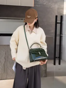 Stylish green crocodile pattern leather crossbody bag with top handle for women fashion.