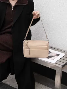 Beige leather multi-zipper shoulder bag, stylish casual crossbody bag for women daily commute.