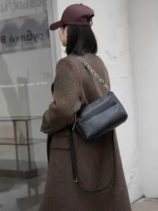 Classic tumbled leather women shoulder bag with metal chain strap and multiple zippers.