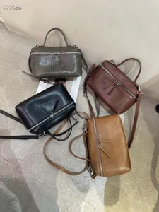 Λεπτομερής λήψη πολύχρωμων δερμάτινων τσαντών με τσέπες με φερμουάρ και λουράκι.