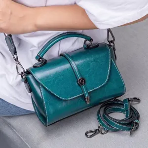 Dark green oil-wax leather women crossbody bag featuring top handle and detachable strap.