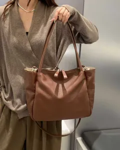 Large capacity soft leather commuter handbag detail, stylish brown shoulder bag for women.