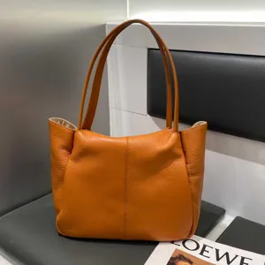 Orange leather tote bag for women, large capacity stylish shoulder bag for daily commute.