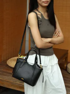 Classic black leather tote bag for women, stylish shoulder bag with spacious interior design.