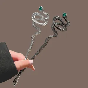 Elegant coiled snake hair fork with green crystal eyes, vintage metal hair bun stick pin.