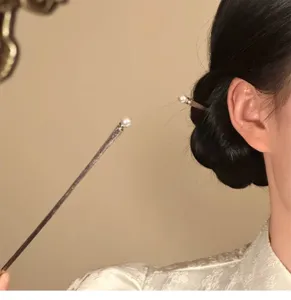 Pearl hair stick detail view showing elegant design and minimalist style for updos.