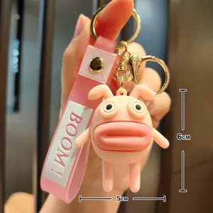 Close-up detail shot of cute funny pink sausage-mouth creature cartoon keychain pendant.