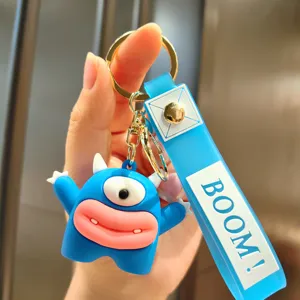 Cute blue monster keychain with funny sausage mouth and boom strap for cute bag charm.