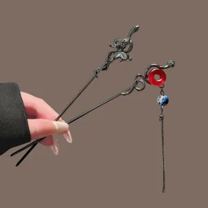 Gothic snake hair stick with butterfly cat-eye stone and red bead tassel for women hair styling.