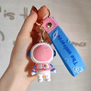 Leuke cartoon astronaut sleutelhanger met blauwe band, perfecte tas en autosleutel accessoire.
