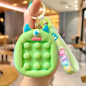 Grüner Cartoon Monster Push Pop Zappeln Spielzeug Schlüsselanhänger Detailansicht