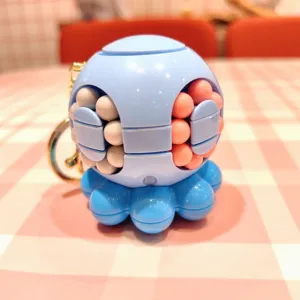 Octopus magic ball fidget toy keychain detail view, blue rotating bead puzzle pendant.