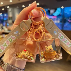 Cute acrylic oil-filled capybara keychain detail, featuring floating glitter and strap.
