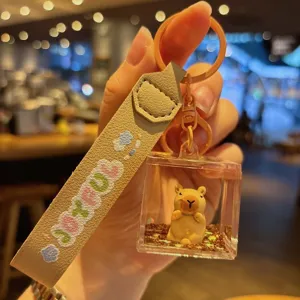 Close-up detail of the cute capybara liquid quicksand keychain featuring a stylish strap.