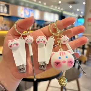 Cute cartoon cat nail clipper keychain set with ear pick and bell pendant for bag.