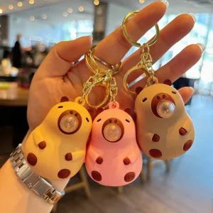 Cute cartoon capybara blow bubble keychain detail, portable toy backpack charm and car key accessory.