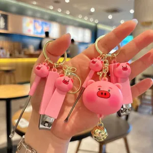 Cute pink pig keychain with nail clipper and ear pick, creative metal keyring pendant gift.