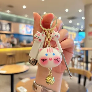 Cute cat keychain set close-up, portable mini nail clipper and ear pick charm pendant detail view.