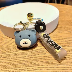 Adorable blue bear head keychain bag charm with metal clasp and stylish letter strap detail.