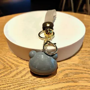 Cute gray bear head acrylic keychain with gold tone hardware and ring pendant accessory.