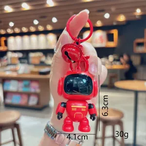 Primer plano detallado del lindo llavero de robot rojo con luz LED y colgante de campana.