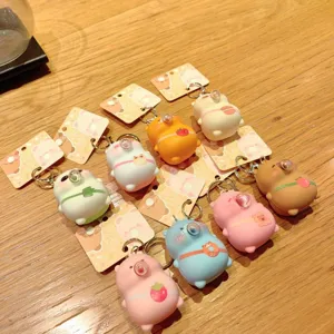 Cute cartoon bubble decompression keychain detail showing colorful cute animal pendant variants on table.