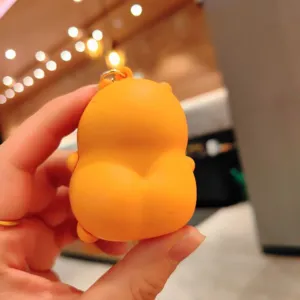 Close-up detail of a cute orange decompression squeeze keychain with metal ring.