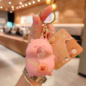 Detailed view of cute pink cartoon bubble-blowing bear decompression keychain pendant.