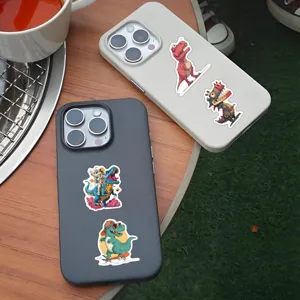 Detailed shot of trendy cartoon dinosaur graffiti stickers displayed on phone cases for DIY decor.