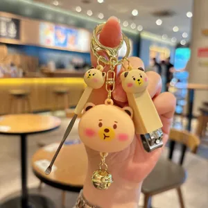 Cute cartoon bear multi-functional keychain with nail clipper and ear pick pendant.