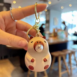 Cute capybara keychain with bubble toy design, perfect bag charm and car key ring accessory.