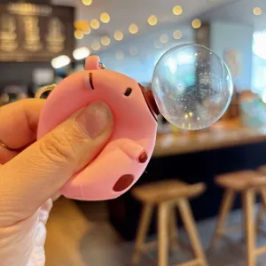Cute bubble blowing capybara keychain, pink squeeze toy pendant for car keys and bags.