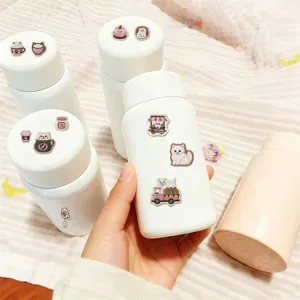 Detailed view of insulated water bottles adorned with cute embroidered cat patches and stickers.