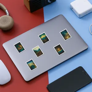 Detailed view of vintage landscape oil painting stickers on a laptop surface for decoration.