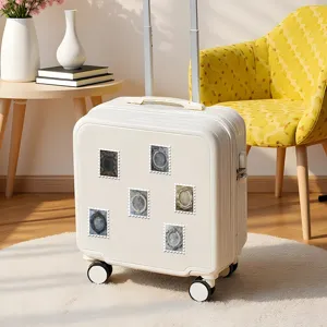 Sturdy white travel luggage suitcase decorated with retro European style vintage photo frame stickers.