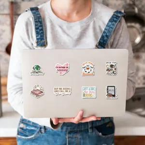 Detail view of aesthetic reading waterproof stickers showcasing creative book designs on a laptop.